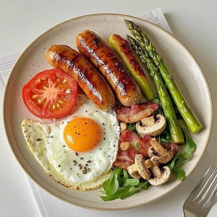 Colorful breakfast platter with fruits, eggs, and sides served on a plate
