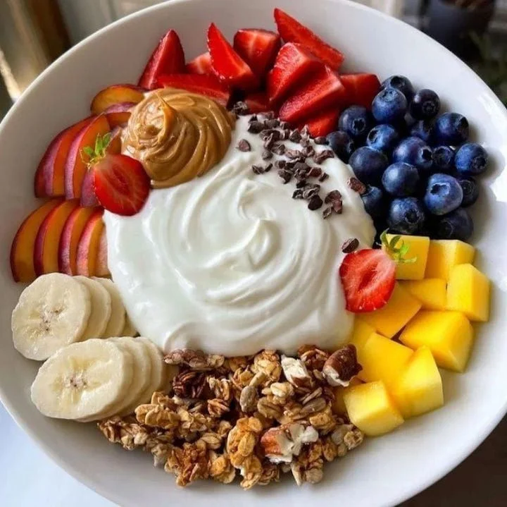 Yogurt breakfast bowl topped with fresh fruits and granola