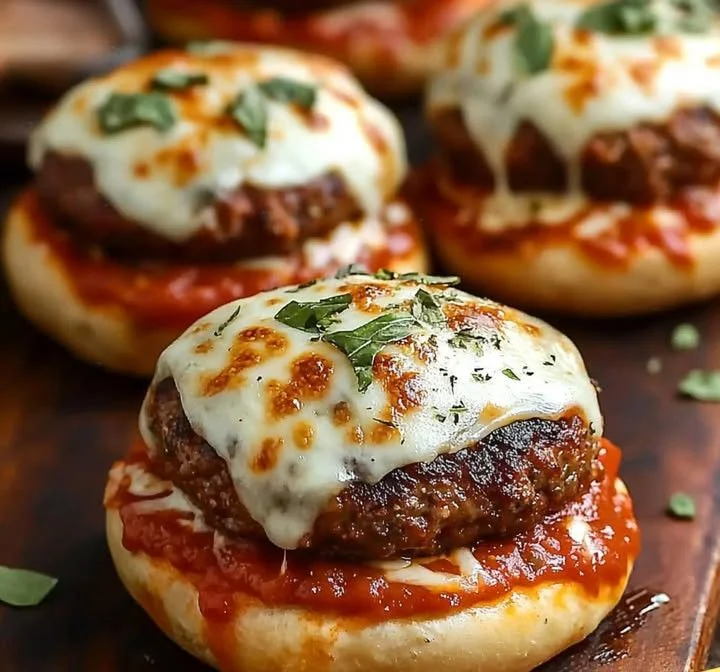 Cheesy Italian pizza burgers topped with melted cheese and fresh ingredients