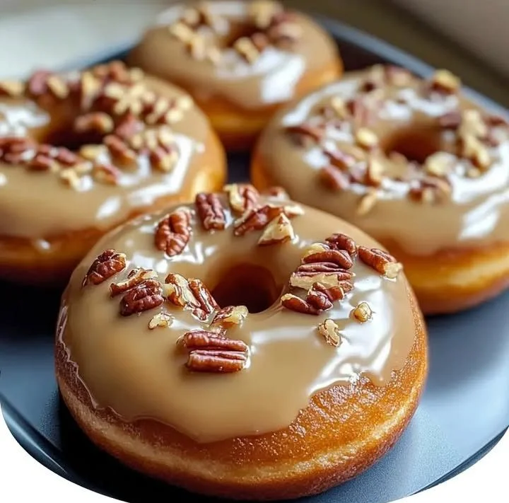 Freshly baked soft butter pecan donuts with a delicious glaze
